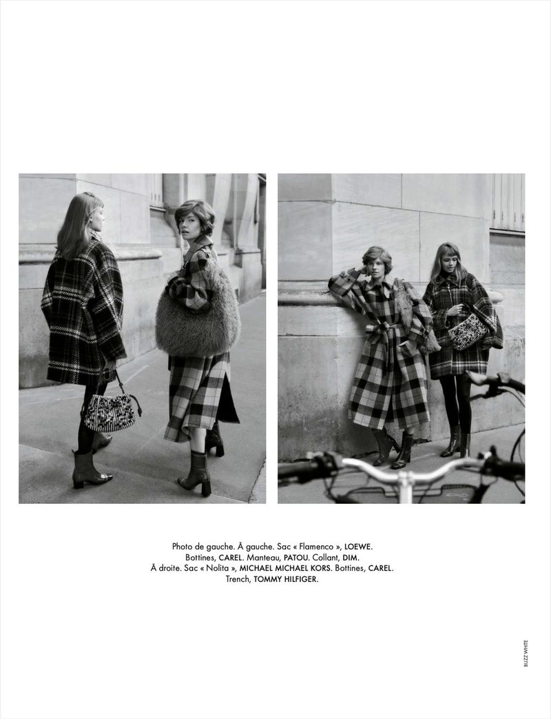 Black and white fashion editorial featuring two women in patterned coats with handbags, posing against a neutral building backdrop.