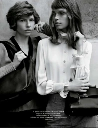 Black and white fashion editorial of two women posing together in knitwear and a ruffled blouse while holding leather bags.