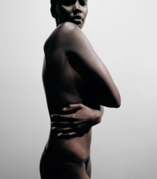 Model photographed in profile against a plain white background for the Necessaire Cypres-Citronne campaign