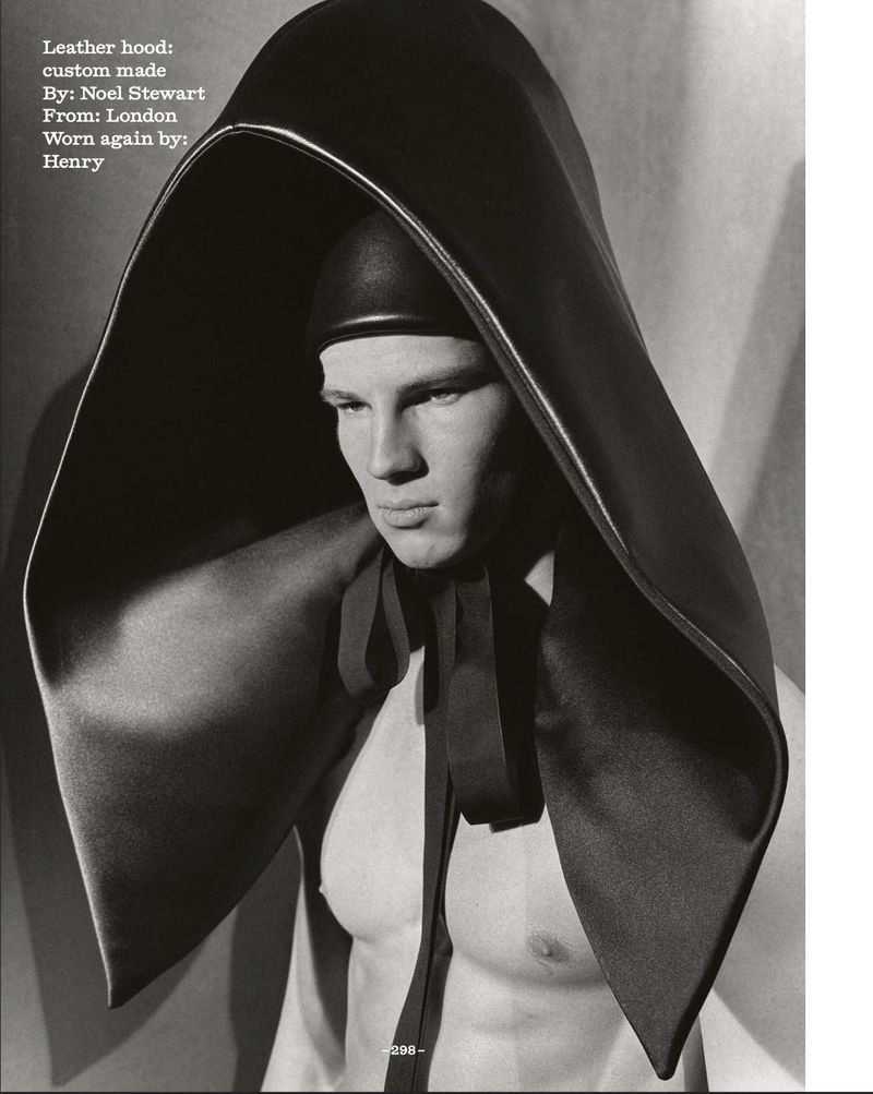 Monochromatic portrait of a muscular man wearing a custom-made black leather hood, shot indoors with studio lighting and subtle post-production.