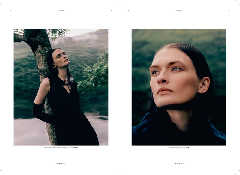 Fashion editorial image featuring a woman in a sleeveless black dress and long gloves, leaning against a tree with a forest background.