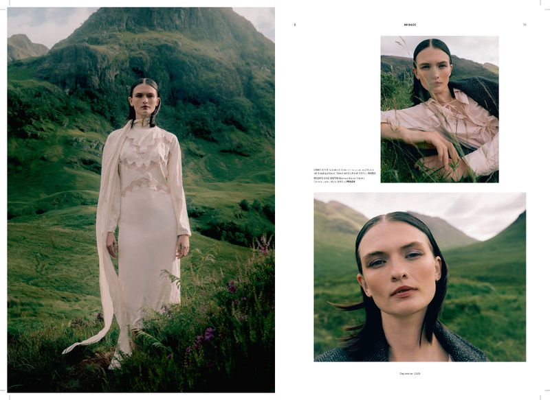 A woman in a flowing gown poses in a grassy field before mountains in this fashion editorial, shot in natural light with an outdoor setting.