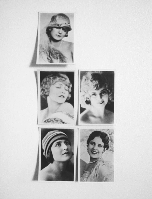 Black-and-white images of five women, displayed on a textured white wall in a vertically-oriented arrangement, each with distinct hairstyles.