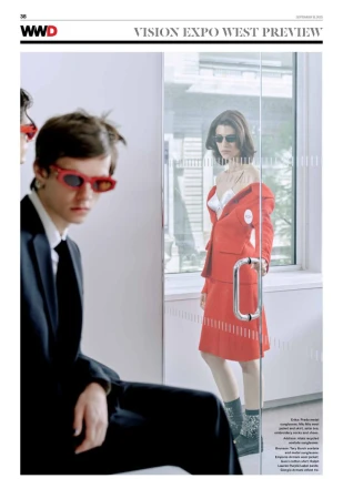 Editorial fashion spread featuring a man in a black suit with red sunglasses and a woman in a red skirt suit behind a glass door.
