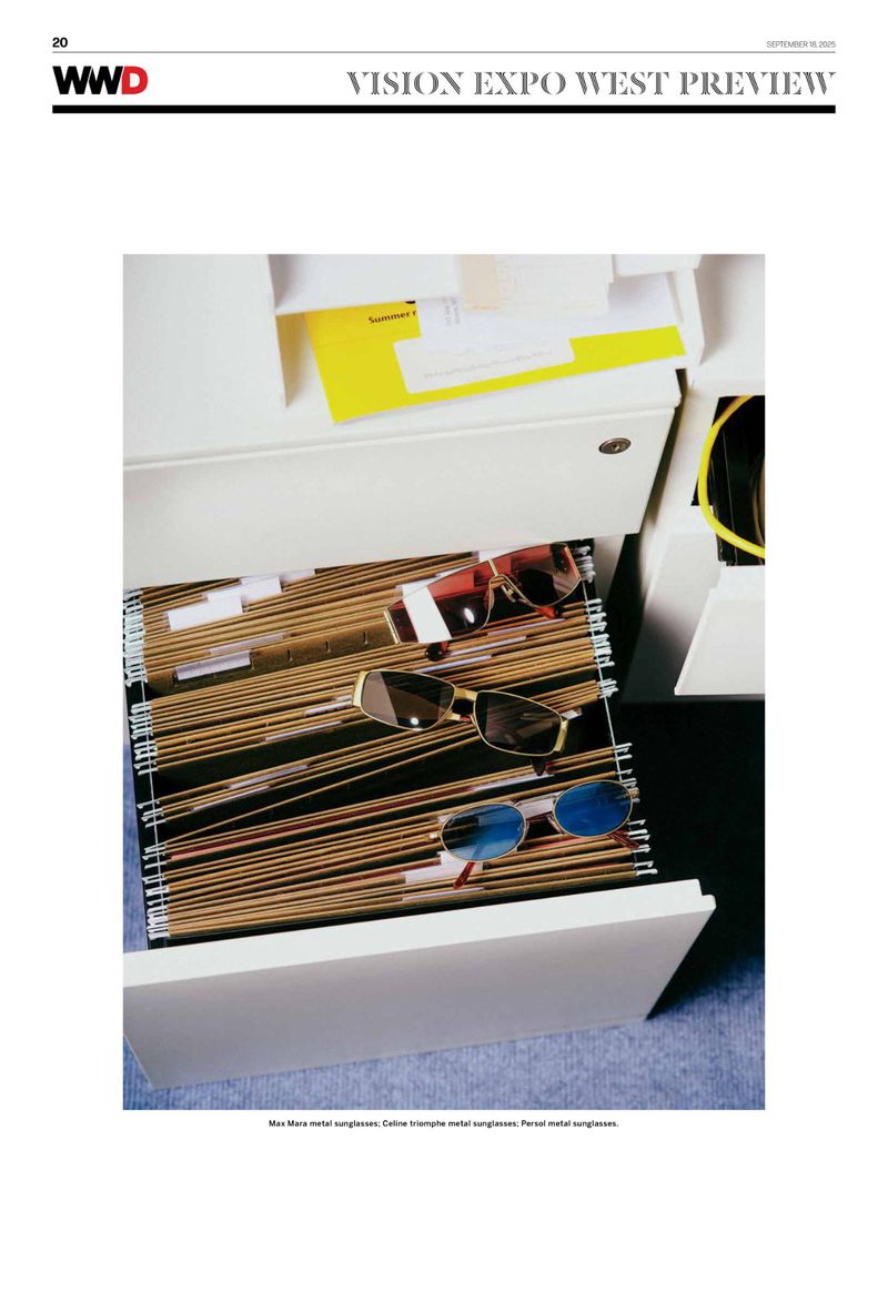 Open filing cabinet drawer with sunglasses on top of file folders in organized rows. The scene is indoors, in bright lighting.