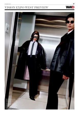 Editorial fashion shot of a stylish couple in black coats and sunglasses inside of an elevator. Classic retro fashion aesthetic.