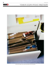Three pairs of metal-frame sunglasses resting on hanging file folders inside an open white office filing cabinet.