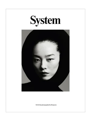 Close-up portrait of Asian female model FeiFei Sun wearing a black hooded garment for System Magazine cover