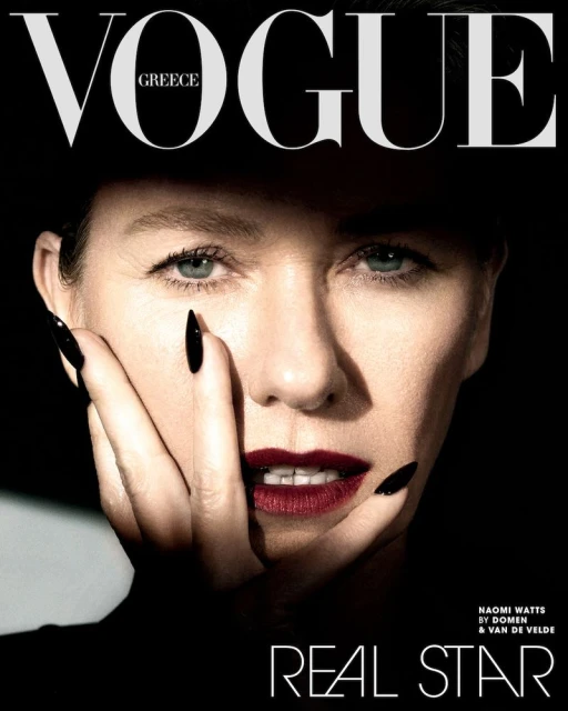 Vogue Greece magazine cover featuring a close-up portrait of Naomi Watts with dark red lipstick and long black nails, on a black background.