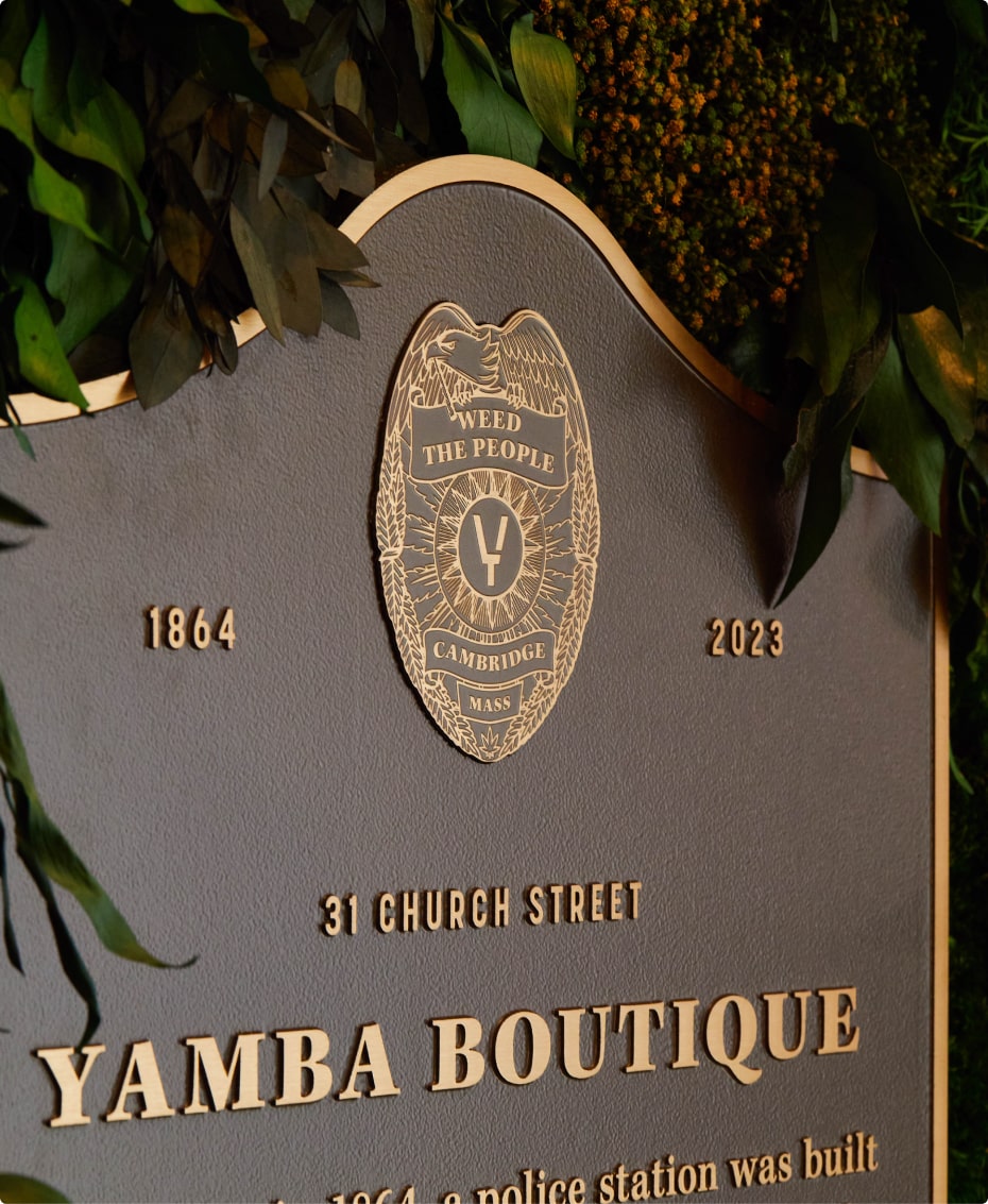 Plaque for Yamba Boutique in Cambridge, Massachusetts. The plaque features the years 1864 and 2023 and the phrase 'Weed The People'.