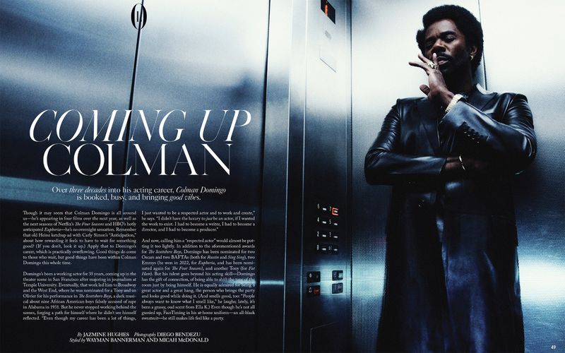 Colman Domingo, striking a stylish pose in an elevator, exudes confidence with a cigar in hand, showcasing a sleek, all-black outfit.