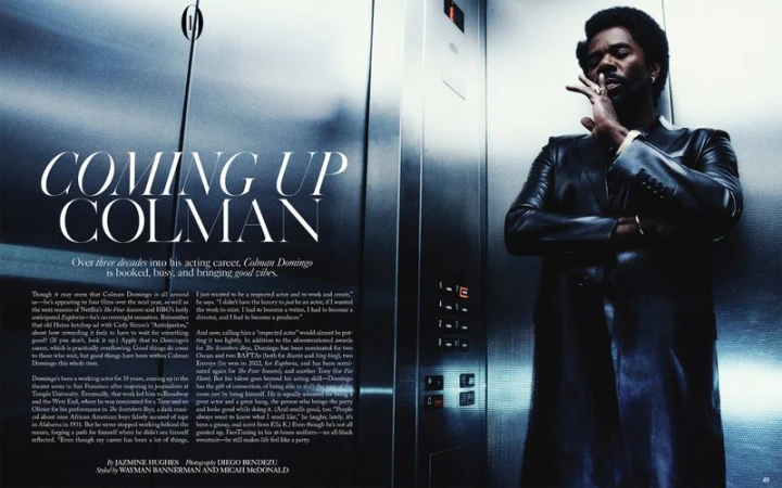 Colman Domingo, striking a stylish pose in an elevator, exudes confidence with a cigar in hand, showcasing a sleek, all-black outfit.