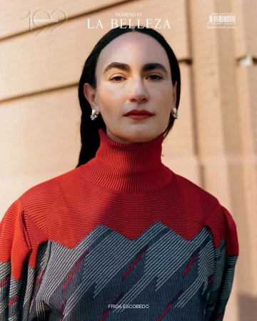 Magazine cover featuring an adult woman with dark hair and light skin wearing a red and grey sweater against a neutral-toned background.