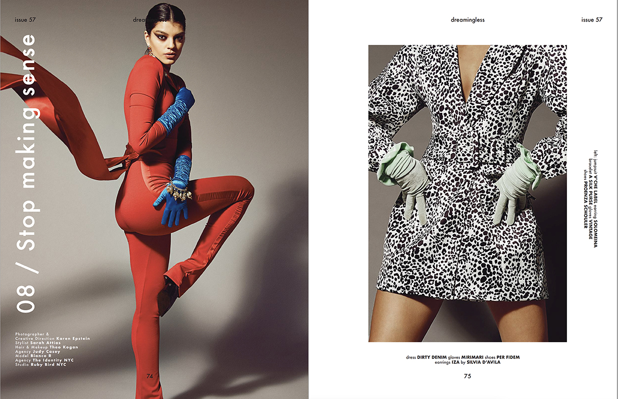 Fashion editorial shot of a woman in a red jumpsuit with blue gloves, alongside a dress with a black and white animal print pattern.