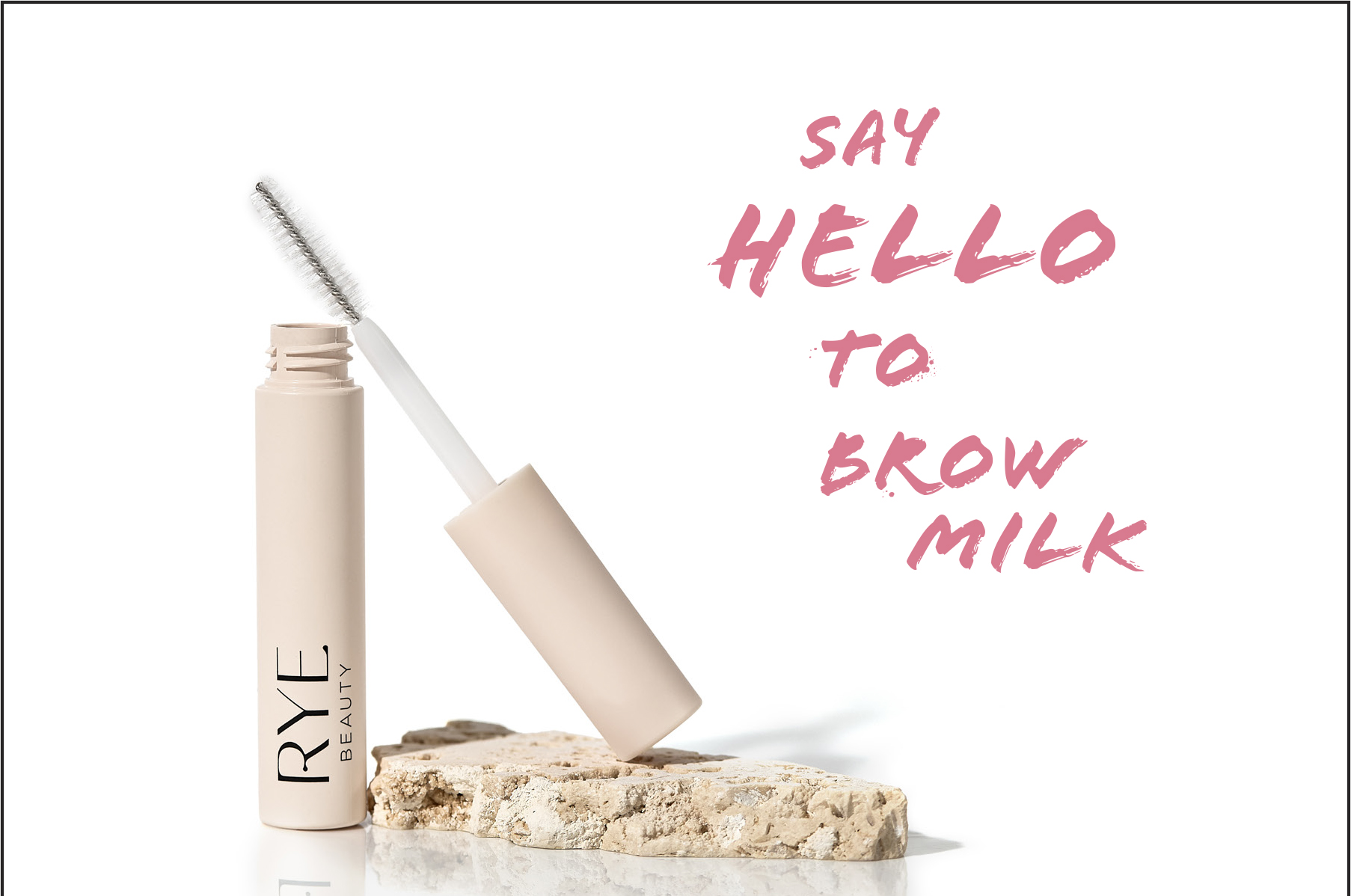 Beige tube of Rye Beauty brow gel and applicator on a stone pedestal against a white backdrop in a beauty product studio shot.