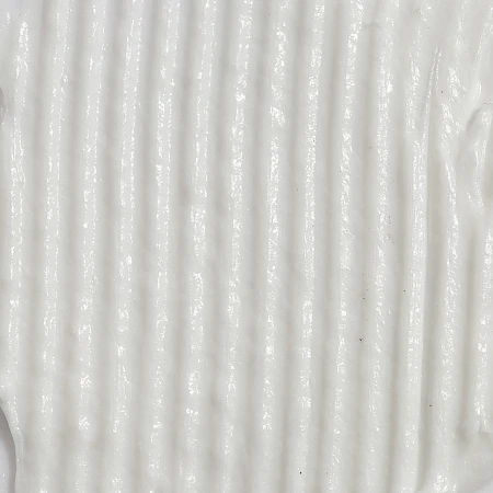 Close-up texture shot of a smooth, white cream with a linear ribbed pattern and a glossy sheen.
