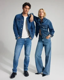 Two models wearing matching denim jackets and jeans posing against a clean neutral background for Mavi FW25