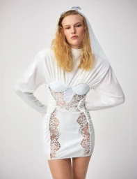 Model Astrid Østergaard wearing a white lace mini dress and veil for Mixte Runaway Bride editorial, photographed by Lala Serrano.
