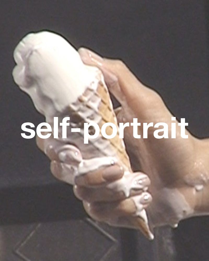 Close-up of a person's hand holding a melting ice cream cone with dripping white cream against a dark gray background. 