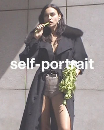 Adult female in a long coat poses outdoors holding fresh produce; a large white self-portrait text overlay is visible.