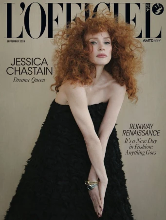 Magazine cover featuring Jessica Chastain in a black dress, styled with voluminous red hair, against a neutral background.