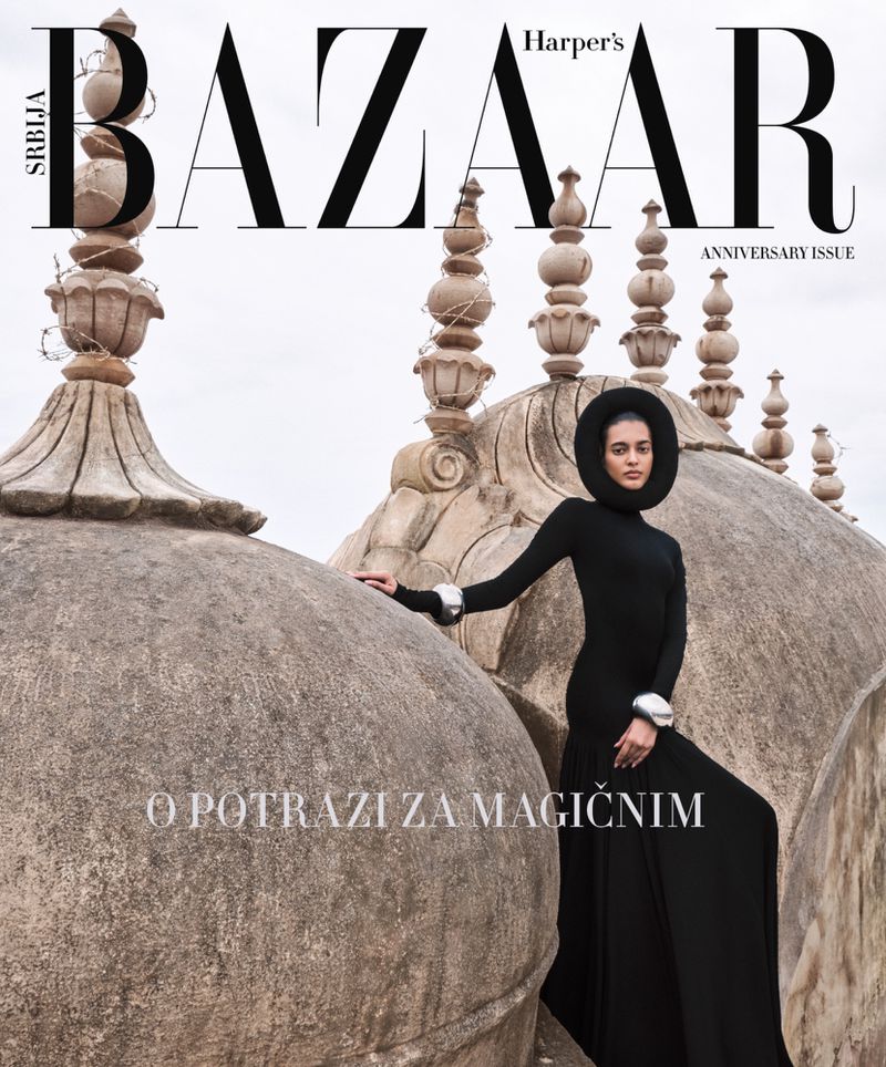 Harper's Bazaar Serbia magazine cover featuring a woman in black gown and headdress posing in front of a historic architectural structure.