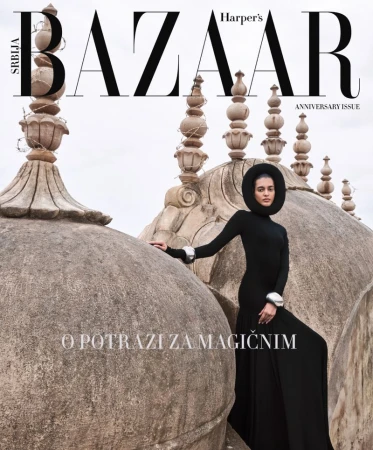 Harper's Bazaar Serbia magazine cover featuring a woman in black gown and headdress posing in front of a historic architectural structure.