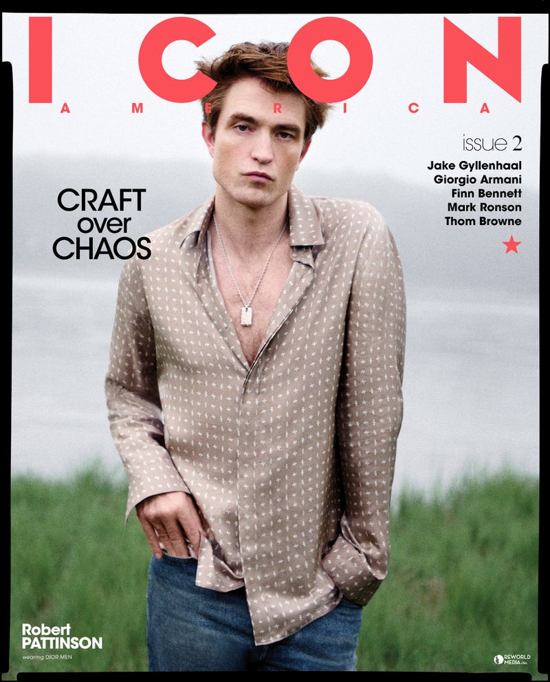 Magazine cover featuring Robert Pattinson in a patterned shirt and jeans, with red and white text, photographed against an outdoor background.