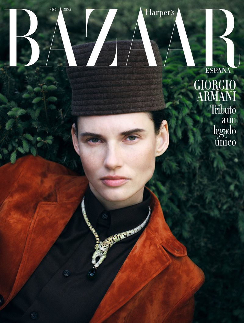 Harper's Bazaar Espana cover featuring a portrait of a woman in a hat and jacket, adorned with a tiger necklace, against a greenery backdrop.