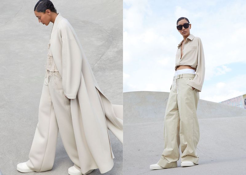Two fashion models pose in tan clothing. One model wears a long tan coat and the other wears a tan button-down shirt and pants.