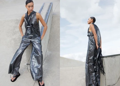 A female model wearing a metallic grey sleeveless top and matching wide trousers poses outdoors against a concrete skatepark ramp.