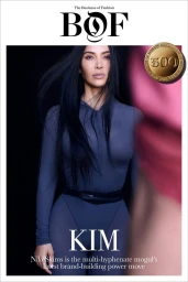 Kim Kardashian wearing a fitted slate grey long-sleeve bodysuit on The Business of Fashion BoF 500 magazine cover against a black backdrop.