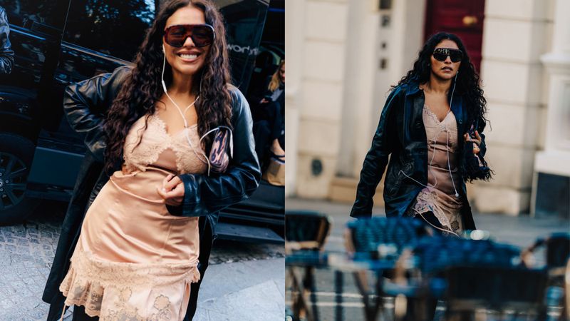 Woman in slip dress and leather jacket posing in urban setting with vehicle. Lifestyle, fashion, and city environment are visible.