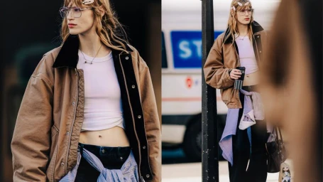 Model wearing an oversized brown jacket, white crop top, and clear glasses outdoors for H&M Inbetween.