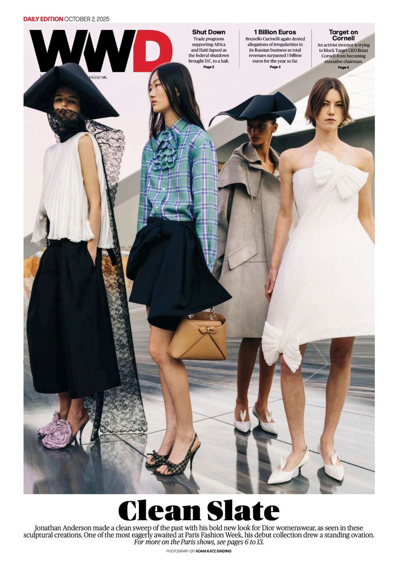 WWD magazine cover featuring four fashion models in studio wearing outfits and shoes, including hats and carrying handbag. 