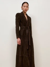 Model wearing a dark brown belted long coat against a clean light background for Nour Hammour Fall Winter 25