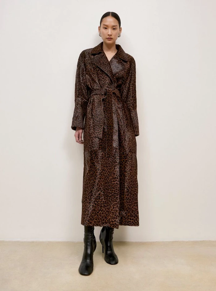 Model in long leopard print belted coat wearing black boots against a neutral background for Nour Hammour Fall Winter 25