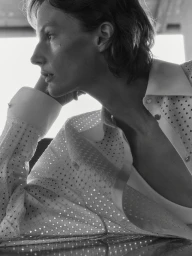 Close-up profile of model Sara Blomqvist wearing a white perforated shirt for Giada 2025 SS Leisure campaign