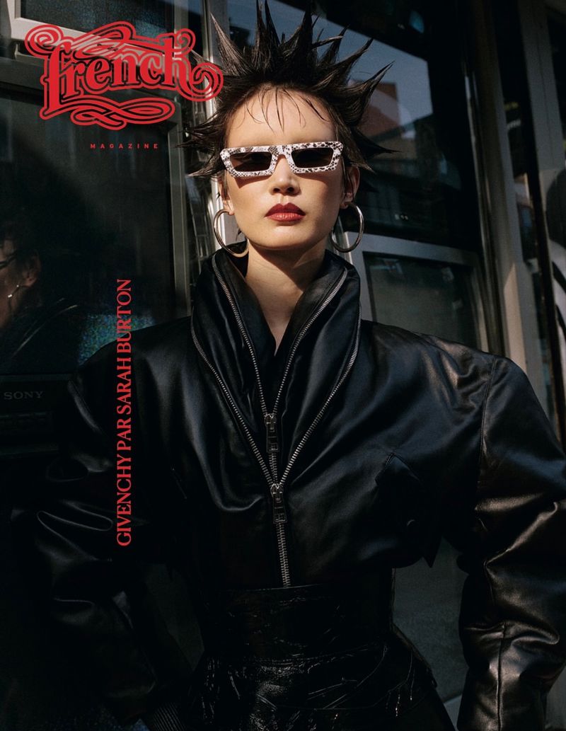 Fashion magazine cover featuring a woman with spiky hair and sunglasses wearing a black leather jacket against an outdoor background.