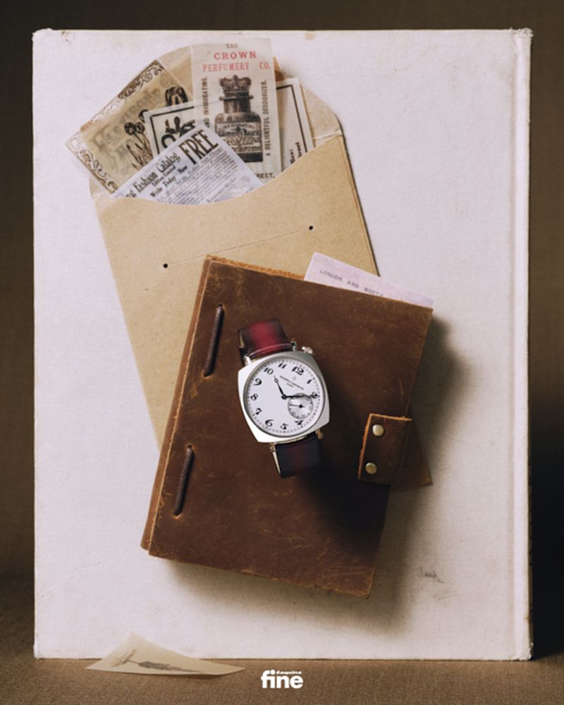 Vintage style still life featuring an open notebook, a watch, an envelope with vintage ephemera, set against a neutral background.