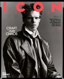 Actor Finn Bennett poses for the ICON America magazine cover wearing a textured black leather coat, white shirt, and tie.