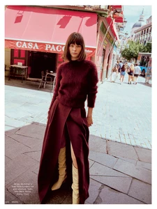 Model wearing a burgundy mohair sweater and long skirt standing on a sunny Madrid street