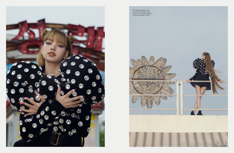 A fashion magazine spread shows a young woman in a black, polka-dot, bejeweled top standing in front of an amusement park, captured in a medium shot.