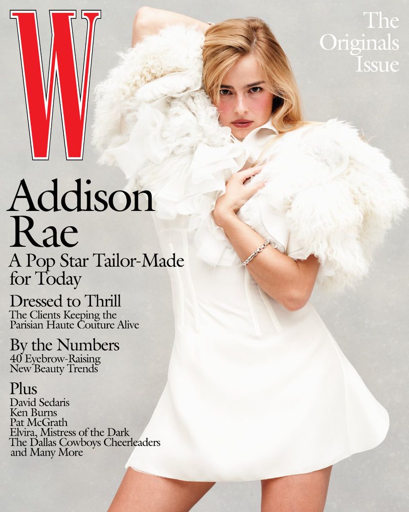 Magazine cover featuring Addison Rae in a white dress and textured shawl against a grey background, with bold red 'W' logo.