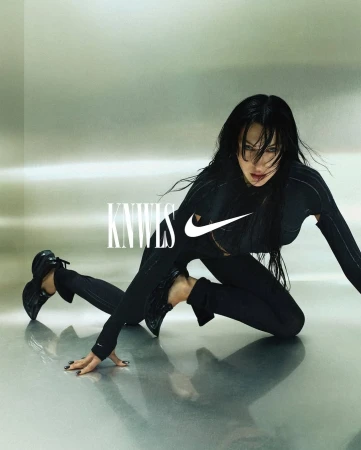 Athletic woman in black sportswear poses on reflective surface with logo and brand text. Fashion forward fitness apparel for women.