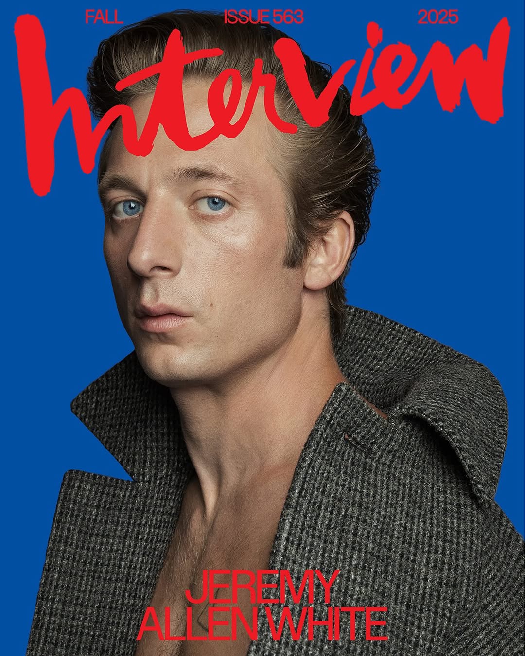 Jeremy Allen White, star of The Bear, is on the cover of Interview Magazine wearing an unbuttoned coat against a blue background.