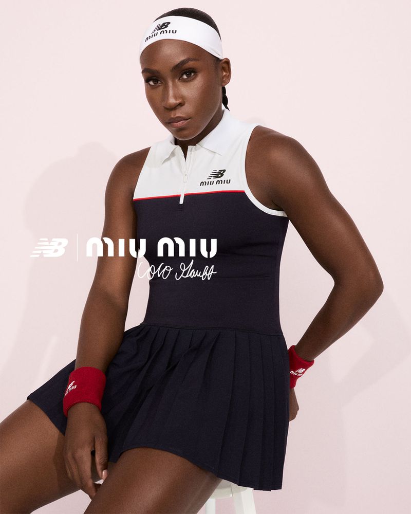 Coco Gauff poses in a Miu Miu tennis dress and headband with New Balance logos against a light pink backdrop in a studio.