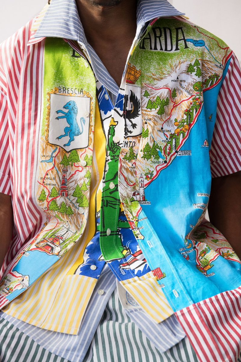 Man's fashion shirt with Garda, Brescia map print. Open collar shows striped lining. Colorful, unique design. Clothing fashion concept.