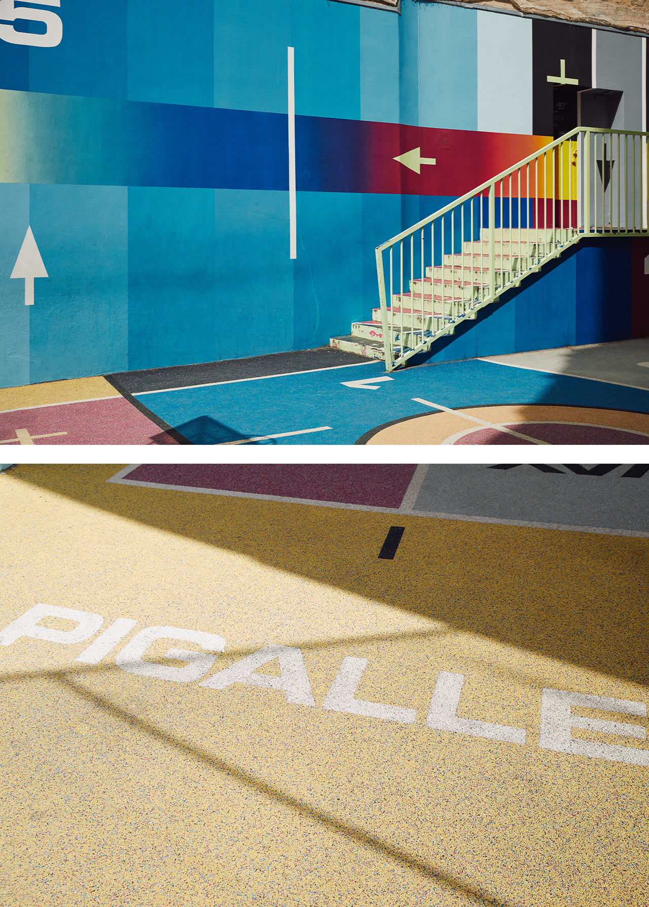Outdoor view of a colorful public playground with a staircase, featuring blue, red, and yellow paint, and geometric shapes.