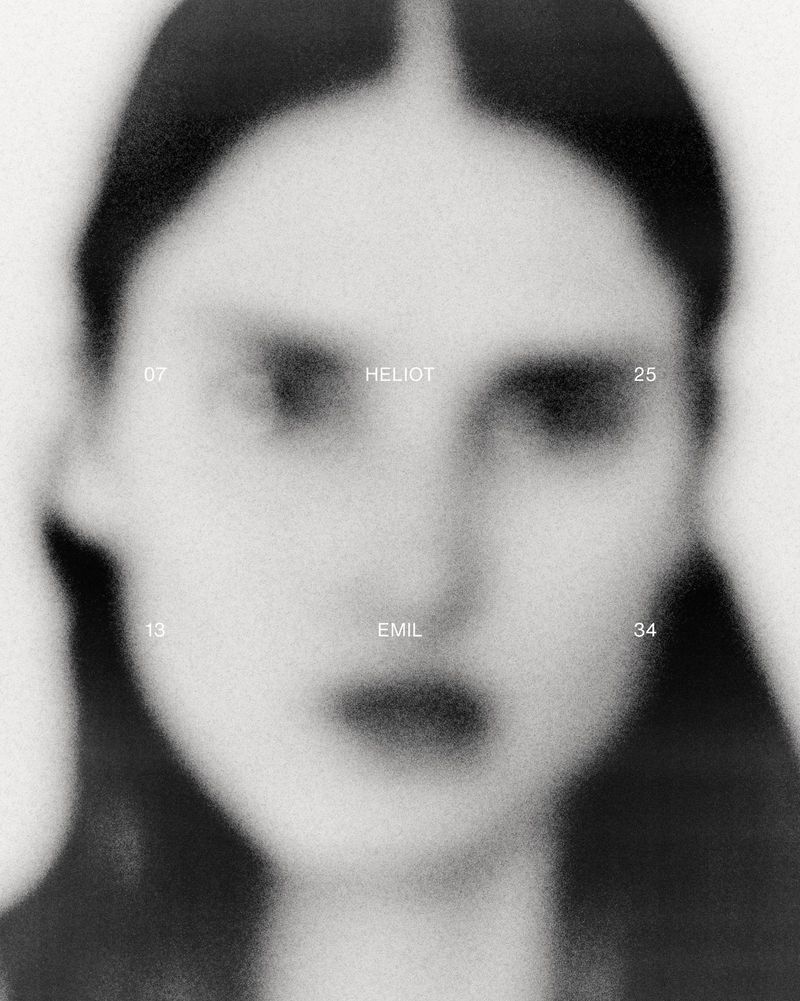 Monochrome portrait of a woman's face with dark hair in pigtails, presented with soft focus and overlaid with typographic elements on a light background.